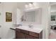 Well-lit bathroom with a modern vanity, ample storage, and a large mirror at 5090 Greens Dr, Lady Lake, FL 32159