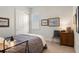 Relaxing bedroom with a gray-toned comforter, classic furnishings, and natural light at 5090 Greens Dr, Lady Lake, FL 32159
