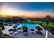 Resort-style pool area with ample lounge seating, mature trees, and sunset views at 5090 Greens Dr, Lady Lake, FL 32159