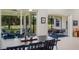Dining area with a large table and chairs, open to an outdoor patio with comfortable seating with golf course view at 5090 Greens Dr, Lady Lake, FL 32159