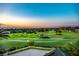 Panoramic view of the golf course at sunset showcasing manicured greens and a serene lake at 5090 Greens Dr, Lady Lake, FL 32159