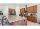 Bright kitchen featuring stainless appliances, granite countertops, a center island with seating, and modern cabinetry at 5090 Greens Dr, Lady Lake, FL 32159