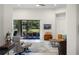 Open-concept living room with neutral tones, comfortable seating, and a seamless transition to the outdoor screened patio at 5090 Greens Dr, Lady Lake, FL 32159