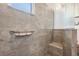 Walk-in shower featuring custom tile work, built-in bench, and glass partition for a luxurious feel at 5090 Greens Dr, Lady Lake, FL 32159