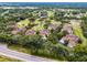 Aerial view of community homes and golf course at 52 Camino Real Blvd, Howey In The Hills, FL 34737