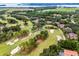Golf course homes are surrounded by lush greenery at 52 Camino Real Blvd, Howey In The Hills, FL 34737