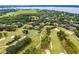 Aerial view overlooking a lush community golf course at 52 Camino Real Blvd, Howey In The Hills, FL 34737