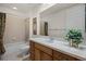 Bright bathroom with a tub, shower, and a wooden vanity with a large mirror at 52 Camino Real Blvd, Howey In The Hills, FL 34737