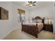 Cozy bedroom with a ceiling fan, decorative bed frame, and neutral color scheme at 52 Camino Real Blvd, Howey In The Hills, FL 34737