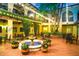 Enchanting courtyard illuminated with string lights, showcasing a fountain and vibrant floral arrangements at 52 Camino Real Blvd, Howey In The Hills, FL 34737