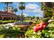 Beautifully landscaped gardens with a fountain, colorful flowers, and lush greenery at 52 Camino Real Blvd, Howey In The Hills, FL 34737