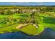 Beautiful golf course with lakes, mature trees, and sandy bunkers next to a luxurious hotel on the green at 52 Camino Real Blvd, Howey In The Hills, FL 34737
