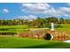 Scenic view of golf course with bridge over pond at 52 Camino Real Blvd, Howey In The Hills, FL 34737