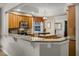 Well-lit kitchen boasts granite countertops, an island, stainless steel appliances, and an open layout at 52 Camino Real Blvd, Howey In The Hills, FL 34737