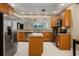 Modern kitchen featuring stainless steel appliances, granite countertops, and center island at 52 Camino Real Blvd, Howey In The Hills, FL 34737