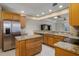 Modern kitchen with stainless steel appliances, granite countertops, and an island at 52 Camino Real Blvd, Howey In The Hills, FL 34737