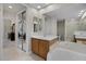 Bright bathroom with a large mirror, double sink vanity, and separate tub and shower at 52 Camino Real Blvd, Howey In The Hills, FL 34737
