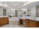 Luxurious main bathroom featuring a large soaking tub, double vanities, and ample counter space at 52 Camino Real Blvd, Howey In The Hills, FL 34737