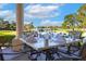 Charming outdoor dining space with scenic water views and elegant table setting at 52 Camino Real Blvd, Howey In The Hills, FL 34737