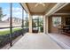 View from screened-in lanai looks out to hedges and neighborhood at 52 Camino Real Blvd, Howey In The Hills, FL 34737