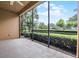 Spacious screened-in patio with a ceiling fan and beautiful landscaping at 52 Camino Real Blvd, Howey In The Hills, FL 34737