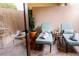 Charming patio with lounge chairs, plants, and a table with drinks creating an inviting outdoor space at 52 Camino Real Blvd, Howey In The Hills, FL 34737