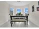 Bright dining area with large windows, tile flooring, and seating for six at 5562 Charleston Avenue, Tavares, FL 32778