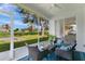 Screened lanai with seating area overlooking well-maintained green lawn and community view at 5562 Charleston Avenue, Tavares, FL 32778