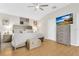Bright and airy main bedroom with wood-look floors, ceiling fan, and light colored walls at 5562 Charleston Avenue, Tavares, FL 32778