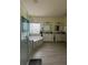 Bright bathroom featuring a large soaking tub, tile accents, and double vanities at 633 Grand Cypress Pt, Sanford, FL 32771
