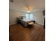 Neutral bedroom with hardwood floors, ceiling fan, and comfortable bed with linens at 633 Grand Cypress Pt, Sanford, FL 32771
