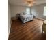 Cozy bedroom with natural light, hardwood floors, ceiling fan, and comfortable bed at 633 Grand Cypress Pt, Sanford, FL 32771