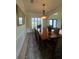 Elegant dining room with wainscoting and decorative chandelier at 633 Grand Cypress Pt, Sanford, FL 32771