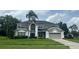 Charming two-story home with attached garage and well-manicured front lawn and mature palm tree at 633 Grand Cypress Pt, Sanford, FL 32771