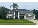 Stately two-story home with manicured lawn and mature landscaping at 633 Grand Cypress Pt, Sanford, FL 32771