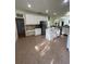 Spacious kitchen features white cabinets, an island, stainless appliances, and a walk-in pantry at 633 Grand Cypress Pt, Sanford, FL 32771