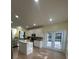 Updated kitchen with tile flooring, stainless steel appliances, and an island overlooking the patio at 633 Grand Cypress Pt, Sanford, FL 32771