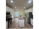 Bright eat-in kitchen featuring white cabinetry, stainless appliances, and island prep area at 633 Grand Cypress Pt, Sanford, FL 32771