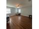 Bright living room with natural light, hardwood floors, ceiling fan, and ample space at 633 Grand Cypress Pt, Sanford, FL 32771