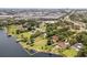 Aerial view of waterfront property showcasing lush landscaping and lake access at 6665 Lake Cane Dr, Orlando, FL 32819