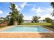A large swimming pool is surrounded by a brick patio and offers waterfront views at 6665 Lake Cane Dr, Orlando, FL 32819