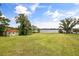 Lush backyard with mature landscaping and waterfront views of the lake at 6665 Lake Cane Dr, Orlando, FL 32819