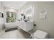 Bright bathroom featuring a double vanity, modern fixtures, and a soaking tub with a view at 6665 Lake Cane Dr, Orlando, FL 32819