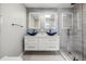 Stylish bathroom with double vanity, modern lighting, and glass-enclosed shower at 6665 Lake Cane Dr, Orlando, FL 32819