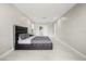 Spacious bedroom with a slider door, tile floors, and a sleek, dark-framed bed at 6665 Lake Cane Dr, Orlando, FL 32819