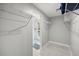 Walk-in closet with wire shelving leading to a shower at 6665 Lake Cane Dr, Orlando, FL 32819