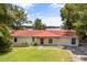Charming home with a red-tile roof and a beautiful waterfront view at 6665 Lake Cane Dr, Orlando, FL 32819