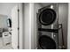 Laundry room area featuring a stacked washer and dryer in silver at 6665 Lake Cane Dr, Orlando, FL 32819
