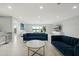 Bright, open living room with modern furnishings and sliding glass doors to the water at 6665 Lake Cane Dr, Orlando, FL 32819