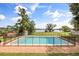 Backyard with pool enclosed by safety fence and waterfront views to the lake at 6665 Lake Cane Dr, Orlando, FL 32819